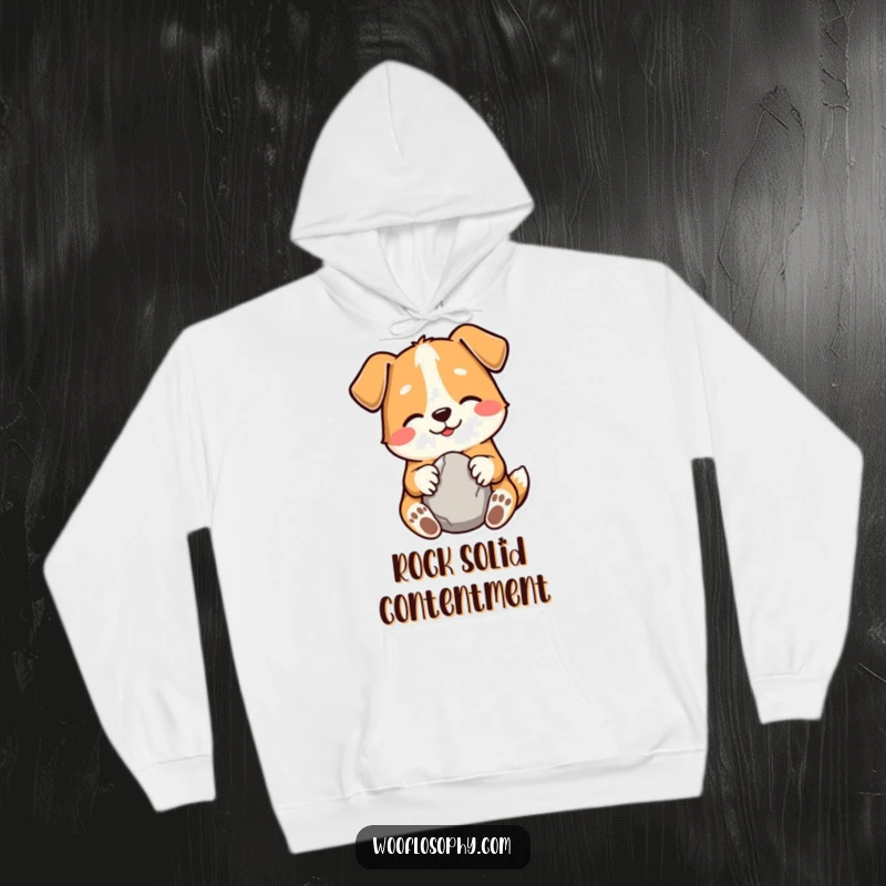 Funny hoodie depicting a gentle, smiling dog holding a smooth stone, symbolizing inner peace and humor.