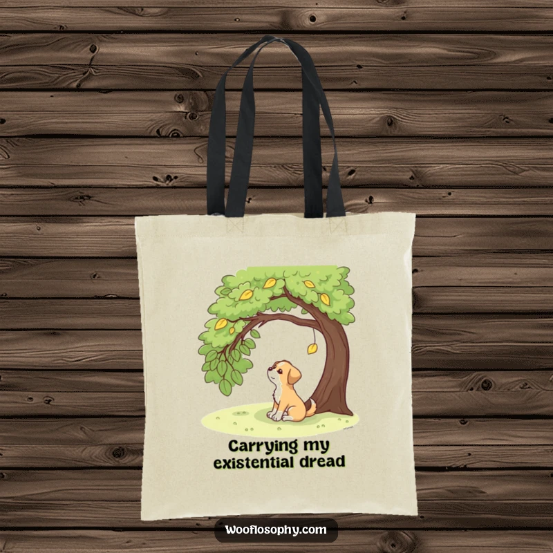 Funny dog sitting under a tree, gazing at a single falling leaf, a peaceful and humorous tote bag.